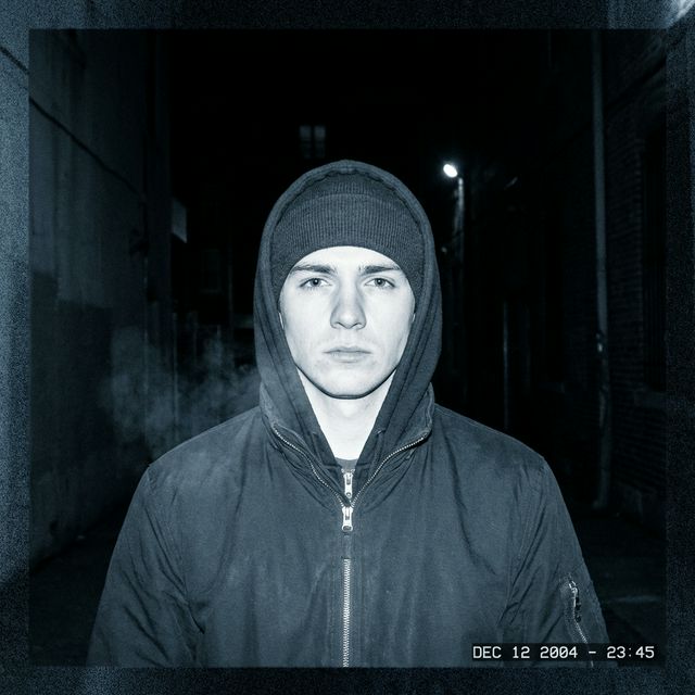 Direct-flash portrait with cool Dusk color grading — desaturated blue-gray tones