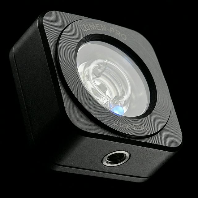 Close-up macro of the Lumos flash — CNC-machined aluminum casing, Xenon tube, and RGB status LED